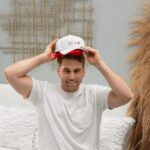 Man putting on LLLT Laser cap